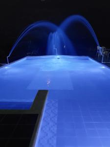a swimming pool with blue water in the dark at Villa Monica in Montenegro