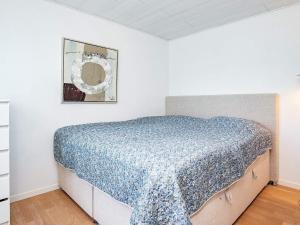 a bedroom with a bed with a blue comforter at Luxury Spa Retreat in Lolland - By Traum Ferienwohnungen in Nakskov +27 photos