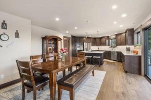 a kitchen with a wooden dining room table and chairs at Summit House in Cle Elum +9 photos