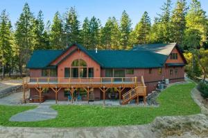 a large red barn with a green roof at Summit House in Cle Elum