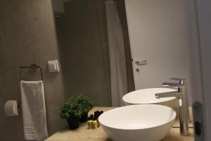 La salle de bains est pourvue de 2 lavabos et d'un grand miroir. dans l'établissement Apartment Sneshka, à Ohrid