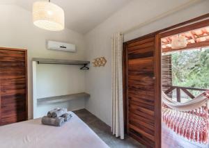 a bedroom with a bed and a large window at Vila Viva in Barra Grande
