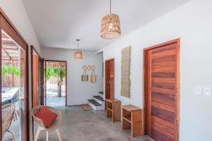 a hallway with a door and a table and a chair at Vila Viva in Barra Grande +9 photos