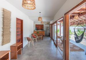 a kitchen and dining room with a table and chairs at Vila Viva in Barra Grande