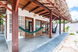 a hammock on the porch of a house at Vila Viva in Barra Grande