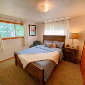 a bedroom with a large bed with blue sheets at Express Gateway in Stevens Point in Stevens Point