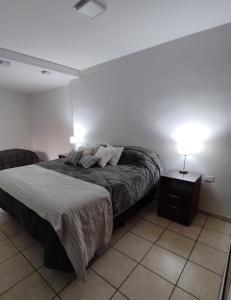 a bedroom with a bed with two lamps on it at Consorcio España 216 in San Juan