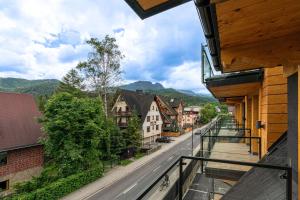 a balcony of a building with a view of a street at Złota Residence & SPA - 500m od Krupówek in Zakopane