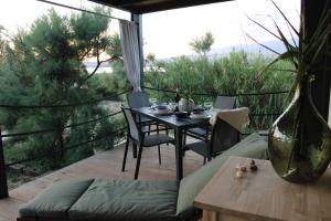 a table and chairs on a patio with a view at Sha-Shaaa Luxury Mobile Home - Terra Park SpiritoS in Kolan