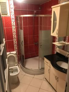 a bathroom with a shower with a toilet and a sink at Cozy Room in Istanbul's Central Uskudar in Istanbul