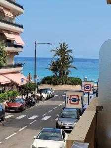 une rue avec des voitures garées au bord d'une plage dans l'établissement Studio entre plages et Monaco climatisé parking, à Roquebrune-Cap-Martin