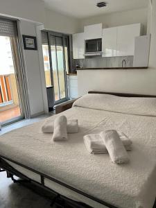 une chambre avec un lit avec des serviettes dessus dans l'établissement Studio entre plages et Monaco climatisé parking, à Roquebrune-Cap-Martin