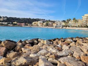 a pile of rocks on the shore of a beach at Studio entre plages et Monaco climatisé parking in Roquebrune-Cap-Martin