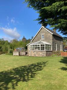 a large stone house with a large yard at Polharrow in Dalry