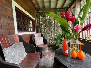 a patio with a table with orange vases on it at Monkey Lodge Panama in Chilibre