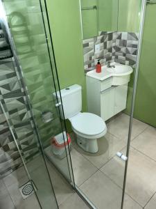 a bathroom with a toilet and a sink and a shower at Recanto das Araucárias - Carazal, Gramado. in Gramado +15 photos