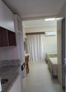 a hotel room with two beds and a kitchen at SPAZZIO Andrian & Silva - INCLUSOS INGRESSOS DO PARQUE in Caldas Novas