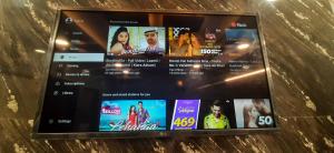 a tablet screen with several movies on it at Aggarwal luxury room with private kitchen washroom and balcony along with fridge, Ac, Android tv, wifi in main lajpat nagar in New Delhi