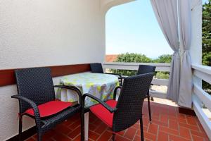 a table and chairs sitting on a balcony at Apartments with parking space Potocnica, Pag - 6338 in Borovići +26 photos