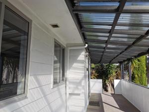 a stairway leading up to a building with a ceiling at New painted 5 bdms spacious house close to the Base in Hamilton