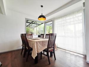 a dining room with a table and chairs and a window at 4 bdm house+sleep-out in Pukete.Close to The Base in Hamilton
