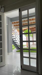 an open door with a view of a staircase at Charlotte House in Canoa Quebrada