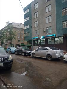 a group of cars parked in front of a building at tsogoo's geust house in Ulaanbaatar