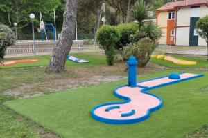 a playground with a toy train on the grass at Charmante petite maison in Soustons
