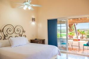 1 dormitorio con 1 cama y balcón con mesa en Los Cabos Golf Resort, Trademark Collection by Wyndham en Cabo San Lucas