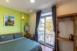 a bedroom with a bed and a large window at D Home Da Lat 3 in Da Lat