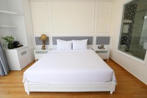 Postel nebo postele na pokoji v ubytování Le Marais Hotel Dalat
