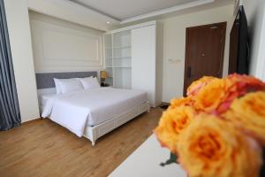 Postel nebo postele na pokoji v ubytování Le Marais Hotel Dalat