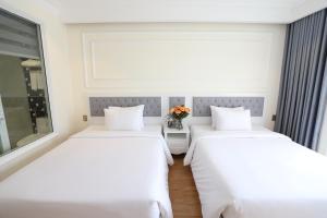 Postel nebo postele na pokoji v ubytování Le Marais Hotel Dalat