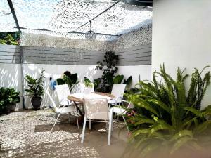 a patio with a table and chairs and plants at Luxury house near by Delphi in Kírra