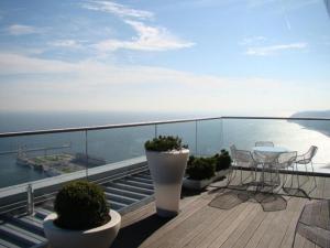 a balcony with a table and chairs and the ocean at Apartamenty Sea Towers in Gdynia