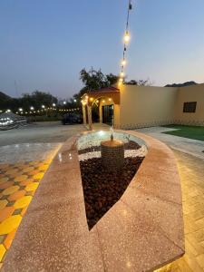 a building with a fountain in the middle of a street at Wadi Alsidra in Hatta