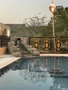 a swimming pool in a yard with a street light at Wadi Alsidra in Hatta