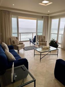 a living room with a view of the ocean at Amazing Ocean Front Condo in Rosarito