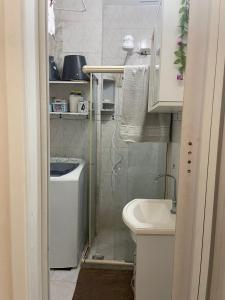 a small bathroom with a toilet and a sink at Apto com Wi-Fi a 200m da Praia de Copacabana/RJ - Cp3 in Rio de Janeiro