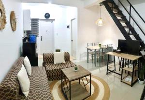 a living room with a couch and a table at Rockmelon Guest House in Mabalacat