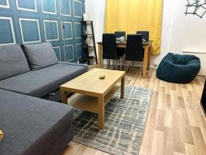 a living room with a couch and a table at Spacious 1 bedroom apartment in the best location in Manchester City Centre in Manchester