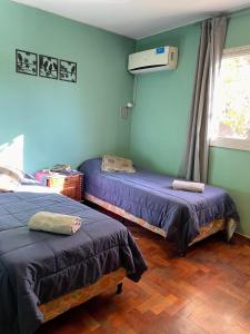 a room with two beds and a air conditioner at Amplio departamento, la mejor ubicación en Mendoza in Mendoza