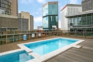 a large swimming pool on the roof of a building at CLD01 - 1 bedroom unit - Bridge Street, Sydney CBD in Sydney