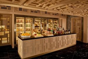 a restaurant with a counter with food on display at JW Marriott Jeju Resort & Spa in Seogwipo +222 photos