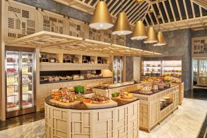a restaurant with a buffet line with food at JW Marriott Jeju Resort & Spa in Seogwipo