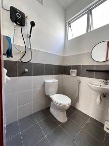 a bathroom with a toilet and a sink at Cozy Apartment 3 Br CityView In KT Near Drawbridge in Kuala Terengganu +14 photos