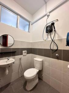 a bathroom with a toilet and a camera on the wall at Cozy Apartment 3 Br CityView In KT Near Drawbridge in Kuala Terengganu