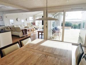 a dining room and living room with a table and chairs at Holiday home Haderslev XXVI in Haderslev