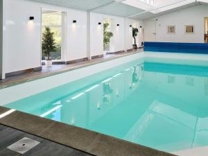 a large swimming pool with blue water at Holiday home Haderslev XXVI in Haderslev