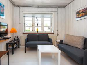 a living room with two couches and a table at 4 person holiday home in Sydals-By Traum in Østerby